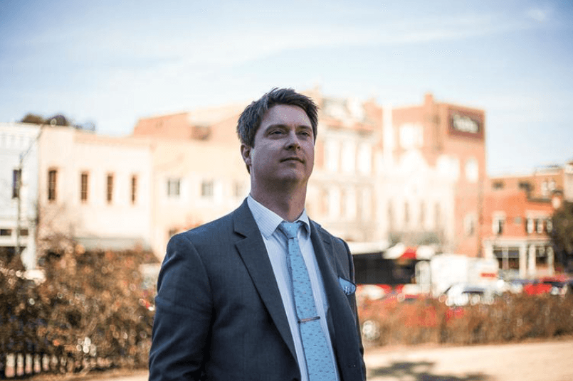 Bradley Griffin in a gray suit and tie on a downtown main street
